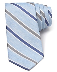 A fine blend of soft linen and plush silk harmonize together on this handsome tie, featuring a refreshing light stripe design that pairs perfectly with your warm weather suiting.