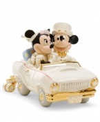 Honeymoon in Disney. Newlyweds Minnie and Mickey Mouse are the picture of happiness in a car is made for the occasion, with M&M vanity plates, luxe gold detail and cans tied to the bumper, all in beautiful Lenox porcelain.