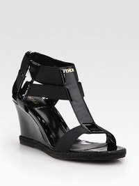 Glassy patent leather wedge enriched by rope trim, comfortable elastic straps and a goldtone nameplate. Patent leather and rope wedge, 3 (75mm)Patent leather and elastic upperLeather liningRubber solePadded insoleMade in ItalyOUR FIT MODEL RECOMMENDS ordering true size. 