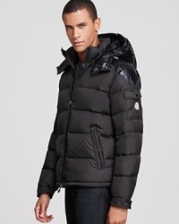 A glossy hood contrasts with the matte shell for a striking designer touch on this brilliant winter coat from Moncler, insulated with down for major warmth and constructed for ease of movement.