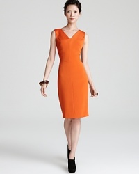 Add color to your closet with this boldly-hued Escada dress with sunburst seaming detail and a structured silhouette.