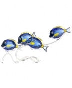 Go fish. This school of Swarovski surgeonfish shimmers in oceanic blues with citrine dorsal fins and lavender-tinted tails. A silvertone metal branch of embossed coral captures the gentle movements of the sea.