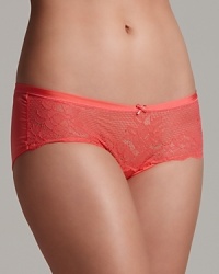 A soft lace hipster made from a smooth fabric with sheen, complete with a scalloped edge and bow at the center front.