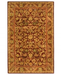 Energetic reds highlight the lush floral motif of this visually impressive area rug from Safavieh. Tufted in India from pure wool, this rug emerges from the annals of antiquity to bring spectacular style and time-honored quality to your home. (Clearance)