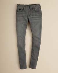 An updated jean in faded gray and a back zip pocket, tailored for a lean, skinny silhouette.