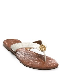 A simple accessory for the beach or walking comfortably around the city; you won't want to wear anything else. Signature embossed leather footbed and metallic signature logo medallion on center of patent strap.