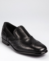 From Salvatore, an elegant loafer crafted from fine Italian leather accented with classic wingtip perforations.