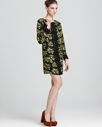 Dramatic lace accents boldly contrast with vivid print in this sumptuous silk Milly shift dress.