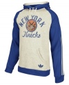 Keep warm as you cheer and rant for the NY Knicks in this pullover hoodie by adidas.