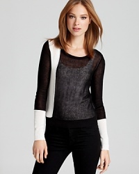 A bold black-and-white color scheme lends a graphic punch to this BCBGMAXAZRIA sweater.