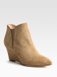 A stable wedge heightens this casual-cool suede ankle boot, with patent leather trim and side elastic gores. Self-covered wedge, 3 (75mm)Suede upper with patent leather trim and elastic goresLeather lining and solePadded insoleImportedOUR FIT MODEL RECOMMENDS ordering one half size up as this style runs small. 