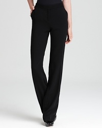 Strike at a distance in impeccably tailored Anne Klein pants, featuring a floor-skimming silhouette accentuated by satin tuxedo stripes for serious fashion presence.