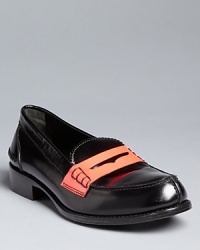 Jil Sander takes old school penny loafers new wave with dramatic neon coral accents.