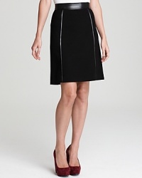 Approach your 9-to-5 style sense with a touch of tough-edge glamour in this DKNY skirt. Leather cording vamps up the sleek silhouette for an edgy, modern finish.