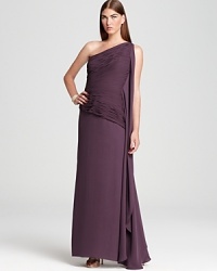 In a jewel-tone hue, Halston Heritage's glamour-rich gown showcases an elegant one-shoulder silhouette. A cascading drape at the side offers a sophisticated finish.