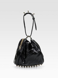 High shine patent leather with a pebbled finish, in a slouchy pouchette shape, adorned with stand-out studs on the circular handle and at the base.Circular handle, about 7 drop Side zip closure Rows of metal feet Fully lined 10W X 7H X 7½D Imported