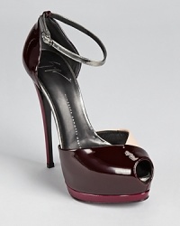 A towering heel gives way to a color blocked silhouette in slick patent leather. From Giuseppe Zanotti.