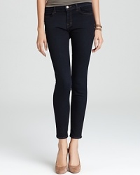 Mid rise J Brand jeans with a skinny-fit silhouette in dark wash denim for an irresistibly chic urban look.