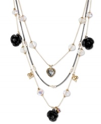 Love with a dark side. Betsey Johnson's illusion necklace features three layers of black glitter roses, crystal hearts, clear faceted beads, gold tone bubble hearts, small glass pearls and black tone chains. Crafted in antiqued gold tone mixed metal. Approximate length: 16 inches + 3-inch extender. Approximate drop: 3-1/2 inches.