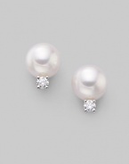 From the Akoya Collection. Classic white cultured pearl studs with sparkling diamond accents, set in 18k gold. 7mm white round cultured pearls Quality: A+ Diamonds, 0.10 tcw 18k white gold Post back Imported