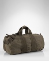 Washed and tumbled for a vintage look, this sturdy canvas duffle encourages owners to go the distance in style.