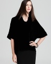 Go va va voom in a plush velvet Eileen Fisher top, artfully draped with a chic cowl neckline for effortless elegance.