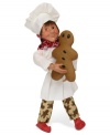 Big on sweets, this little Byers' Choice baker puts the finishing touches on a traditional gingerbread man. He's dressed the part too, wearing cookie-patterned pants with traditional chef's whites.