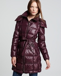 A rich jewel tone and a hint of shine lend glossy luster to a Burberry Brit down coat, cinched at the waist for a chic approach to cold-weather style.