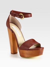 An adjustable ankle strap wraps around this chic faux leather design, resting on a tall wooden platform heel. Wooden heel, 5½ (140mm)Wooden platform, 1¼ (30mm)Compares to a 4¼ heel (110mm)Faux leather upperFaux leather liningRubber trek solePadded insoleMade in ItalyThis style runs large. We recommend ordering one half size down for a standard fit. 