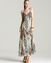 Flourished with an exotic print, this GUESS maxi dress is casual enough for daytime shopping and striking enough for seaside cocktais.