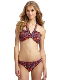 THE LOOKSpirited abstract animal and floral printAdjustable halter straps tie at neckBands crisscross at center with V-shaped openingPadded cups and side boningBack clasp closureTHE MATERIAL80% nylon/20% spandexFully linedCARE & ORIGINHand washImportedPlease note: Bikini bottom sold separately. 