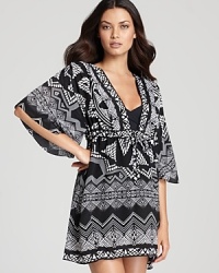 A graphic, Chantilly lace print brightens up a wear-with-anything black backdrop in this Gottex cover up, perfect with the coordinating swimwear or the rest of your seaside favorites. It does double duty as a minidress or a tunic with white jeans.