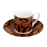 Whimsical drinkware to add fun and color to the table. Konitz mugs feature the highest quality color and glaze. A collage of black, jumbled letters on a brown ground.