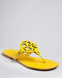 You'll flip for these Tory Burch thong sandals that pop in boldly dramatic color with cut out logo accents.