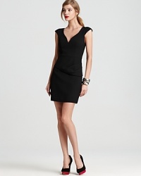 An asymmetrical peplum adds interest to this Black Halo dress--a chic, modern twist on the classic LBD.