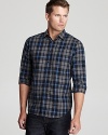 Clean up your look with a quick change into this plaid button-down, tailored for a slim fit to match your modern attire.