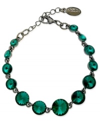 Circular chic. This bracelet from GUESS is crafted from hematite-tone mixed metal with teal glass crystal stones adding a vibrant touch. Item comes packaged in a signature GUESS Gift Box. Approximate length: 7-1/2 inches.