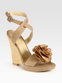 Adjustable, soft nubuck leather straps and an artful flower adornment add ladylike vibes to this timeless straw wedge. Straw wedge, 4 (100mm)Covered platform, ½ (15mm)Compares to a 3½ heel (90mm)Suede and straw upperLeather lining and solePadded insoleMade in SpainOUR FIT MODEL RECOMMENDS ordering true size. 