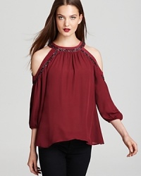 Add a dose of glamorous allure to your wardrobe with this cold-shoulder Madison Marcus top adorned with sparkling sequins. Marrying two of the season's hautest trends-jewel tones and shine-this style is a stellar acquisition piece.