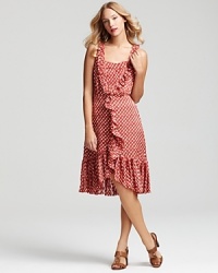 Romantic whimsy arrives with a striking Tory Burch polka dot dress, featuring flounced ruffle trim and a feminine, vintage-inspired silhouette.