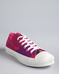 Classic Converse All Star sneakers get a kick from a vibrant heart and flower print.