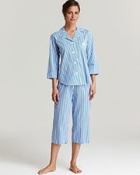 A classic striped pajama set with a three-quarter sleeve top and matching capri pants.