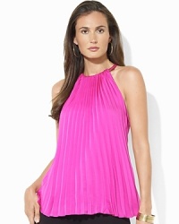 A halter neckline and a pleated front add elements of flirty femininity to a sleek silk halter top.