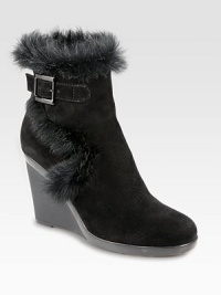 Practical yet fashion-forward, a heightened suede ankle boot trimmed with lush rabbit fur. Rubber wedge, 3¾ (95mm)Rubber platform, ½ (15mm)Compares to a 3¼ heel (80mm)Weatherproof suede upper with rabbit fur trimAdjustable buckle strap and inside zipBreathable microfiber liningSlip resistant rubber solePadded insoleMade in Italy