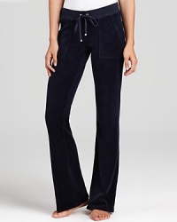 Snap-patch back pockets lend a utility-inspired feel to Juicy Couture's signature velour lounge pants.