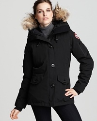 Canada Goose's low-hip length jacket boasts an adjustable down hood with luxe fleece lining and a removable Coyote fur ruff for versatility.