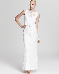 Luxe in lace, Tadashi Shoji's ladylike dress shows off a sleeveless silhouette and a flattering, ribbon-detailed waist.