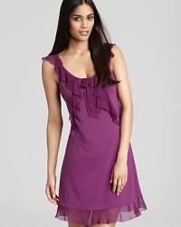 A sleeveless chemise with cascading ruffles along neckline and hem.