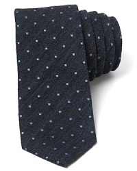 With an underlay of subtle herringbone and an allover pattern of dots, this skinny modern tie deserves attention.