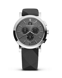 Burberry reinvents the classic chronograph with modern ideas. Three hand analog watch has three eyes. Round grey/black check etched dial with grey/black check fabric strap. Imported from Switzerland.